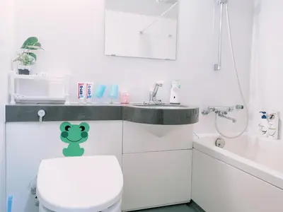 a white bathroom with a toilet and a sink at ohayo\u672c\u6240 in Tokyo