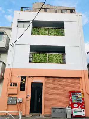 an orange and white building with a door at ohayo\u672c\u6240 in Tokyo