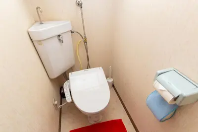 a small bathroom with a toilet and a sink at SquareHouse Nishiarai in Tokyo