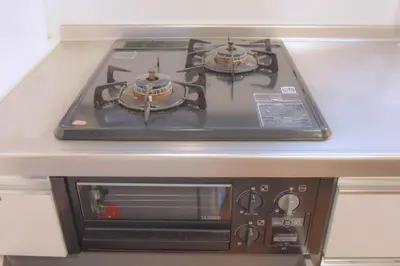 a stove with two pots on top of it at TOMARIE Residential Suite Edogawa in Tokyo