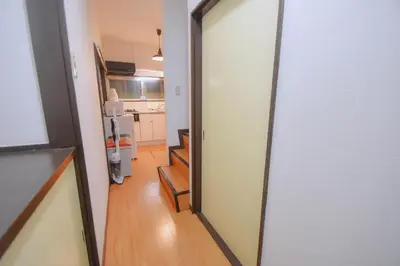 a hallway with a door leading to a kitchen at TOMARIE Residential Suite Edogawa in Tokyo