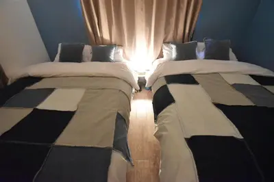 two beds sitting next to each other in a room at TOMARIE Residential Suite Edogawa in Tokyo