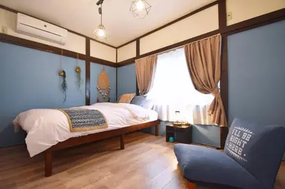 a bedroom with a bed and a window and a couch at TOMARIE Residential Suite Edogawa in Tokyo