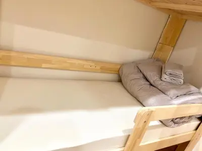 a couple of bunk beds in a small room at Upper Hotel Ryogoku in Tokyo