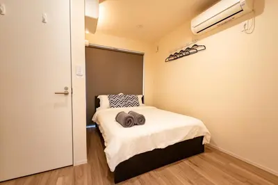 a small bedroom with a bed and a window at Ueno Garden House - 2 mins walk to subway, 2 mins train to Akihabara, 2 mins train to Asakusa in Tokyo
