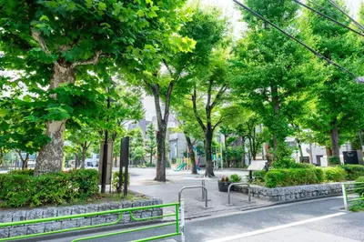 a park with benches and trees in a city at Ueno Garden House - 2 mins walk to subway, 2 mins train to Akihabara, 2 mins train to Asakusa in Tokyo