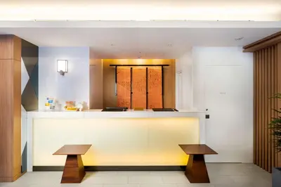 a lobby with a counter and two benches at Best Western Hotel Fino Tokyo Akasaka in Tokyo