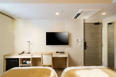 a room with two beds and a television on the wall at Best Western Hotel Fino Tokyo Akasaka in Tokyo
