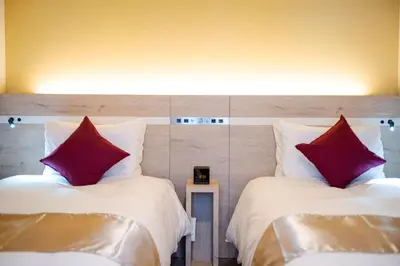 two beds with red pillows sitting next to each other at Best Western Hotel Fino Tokyo Akasaka in Tokyo