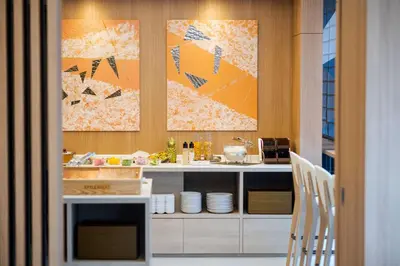 a kitchen with two paintings on the wall at Best Western Hotel Fino Tokyo Akasaka in Tokyo