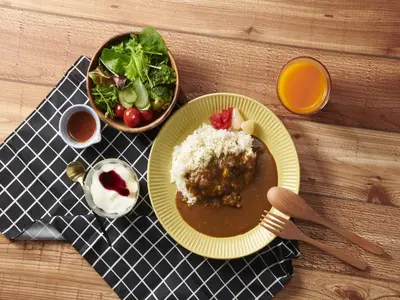 a plate of food with rice and a bowl of salad at Keio Presso Inn Kanda in Tokyo