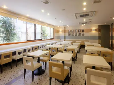 an empty restaurant with tables and chairs at Keio Presso Inn Kanda in Tokyo