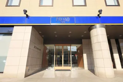 a entrance to a building with a blue sign on it at Keio Presso Inn Otemachi in Tokyo
