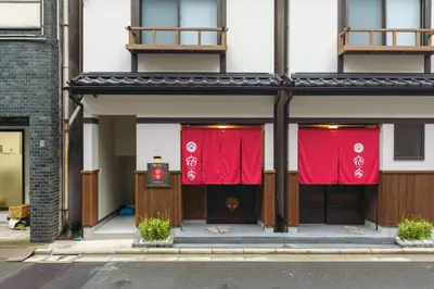 a building with red curtains on the front of it at YADOYA Sennokawa in Tokyo