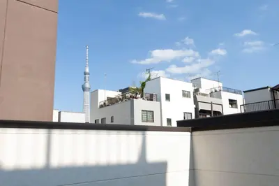 a view of some white buildings with a tv tower at YADOYA Asakusa-Honkan in Tokyo