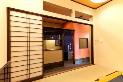 a room with a sliding glass door with a kitchen at YADOYA Asakusa-Honkan in Tokyo