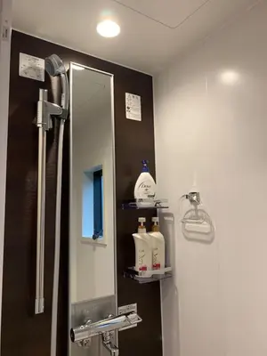 a bathroom with a shower with a mirror and a sink at YADOYA Asakusa-Honkan in Tokyo