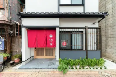 a red curtain on the door of a building at YADOYA Hakuteian in Tokyo