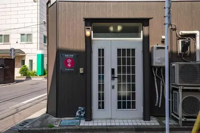 a door on the side of a building at YADOYA Chigusacho in Tokyo