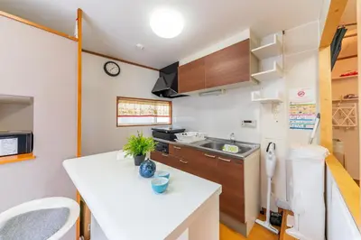 a kitchen with a white counter top in a room at YADOYA Chigusacho in Tokyo