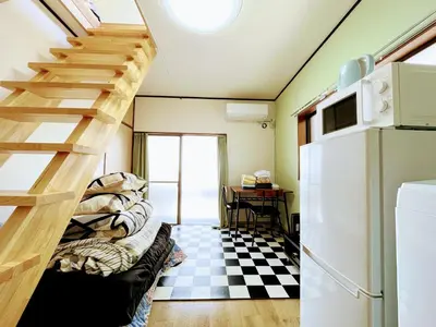 a room with a staircase and a checkered floor at House Kadoi201 in Tokyo