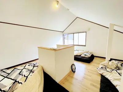 a room with two beds and a cabinet in it at House Kadoi201 in Tokyo