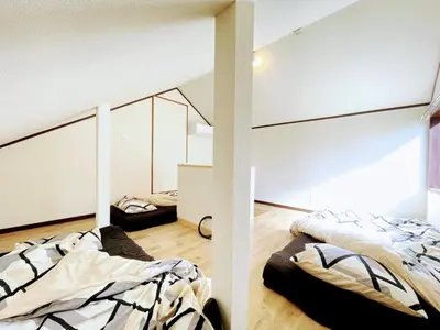 two beds in a room with a window at House Kadoi201 in Tokyo