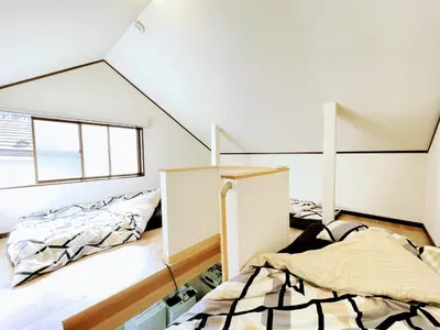 two beds in a room with a attic at House Kadoi201 in Tokyo