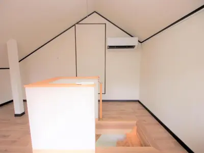 a white room with a triangle on the wall at House Kadoi201 in Tokyo