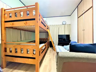 a bunk bed in a room with a couch at House Kadoi202 in Tokyo