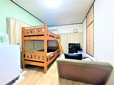 a living room with a loft bed and a couch at House Kadoi202 in Tokyo