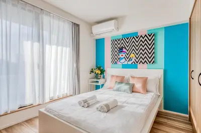 a bedroom with a large bed with a blue wall at Ostay Nippori Hotel Apartment (Nishi-Nippori Sta.) in Tokyo