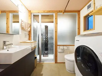 a bathroom with a sink and a washing machine at YADOYA Kisakata in Tokyo