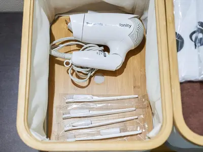 a hair dryer and utensils in a suitcase at YADOYA Kisakata in Tokyo