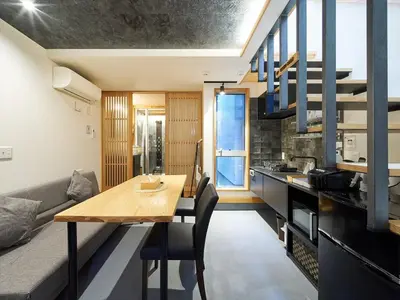 a kitchen and dining room with a table and a couch at YADOYA Kisakata in Tokyo