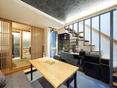 a kitchen and dining room with a wooden table in a room at YADOYA Kisakata in Tokyo