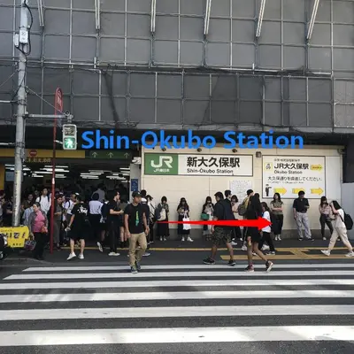 a group of people crossing a street at a crosswalk at Hotel Koryukaku in Tokyo