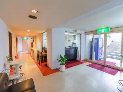 a lobby of a building with a table and chairs at Hotel Koryukaku in Tokyo