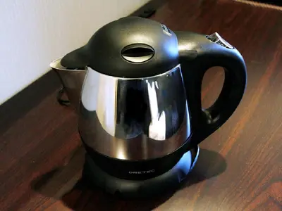 a black and silver tea kettle sitting on a table at HOTEL LiVEMAX Asakusa-Ekimae in Tokyo
