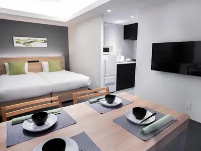 a room with a dining table and a bed at MIMARU Tokyo Shinjuku West in Tokyo