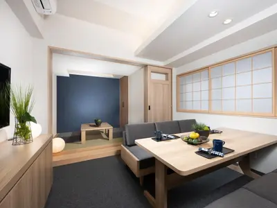 a living room with a table and a tv at MIMARU Tokyo Shinjuku West in Tokyo