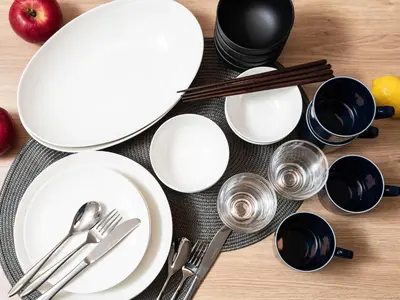 a table with white plates and utensils on it at MIMARU Tokyo Shinjuku West in Tokyo