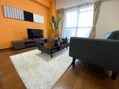 a living room with a couch and a television at Residential Hotel Bevel Tokyo in Tokyo