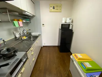 a small kitchen with a sink and a microwave at Residential Hotel Bevel Tokyo in Tokyo