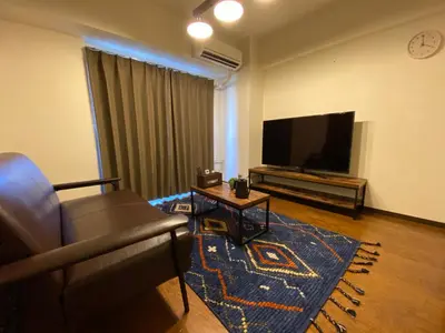 a living room with a couch and a flat screen tv at Residential Hotel Bevel Tokyo in Tokyo
