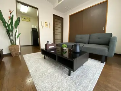 a living room with a couch and a coffee table at Residential Hotel Bevel Tokyo in Tokyo