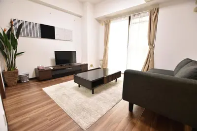 a living room with a couch and a coffee table at Residential Hotel Bevel Tokyo in Tokyo