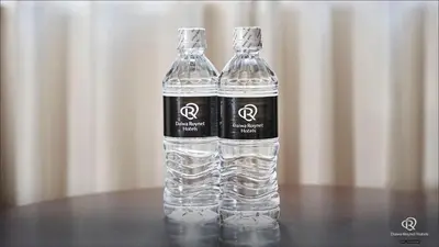 a bottle of water sitting on top of a table at Daiwa Roynet Hotel Tokyo Kyobashi PREMIER in Tokyo