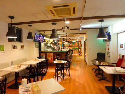 a restaurant with tables and chairs and a bar at \u90fd\u96fb\u5c4b TodenHotel in Tokyo