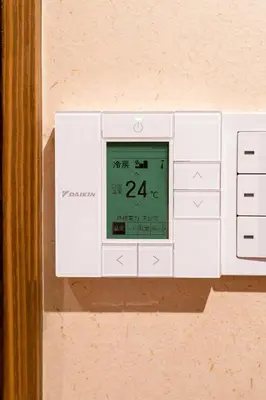 a clock on the side of a wall at \u90fd\u96fb\u5c4b TodenHotel in Tokyo